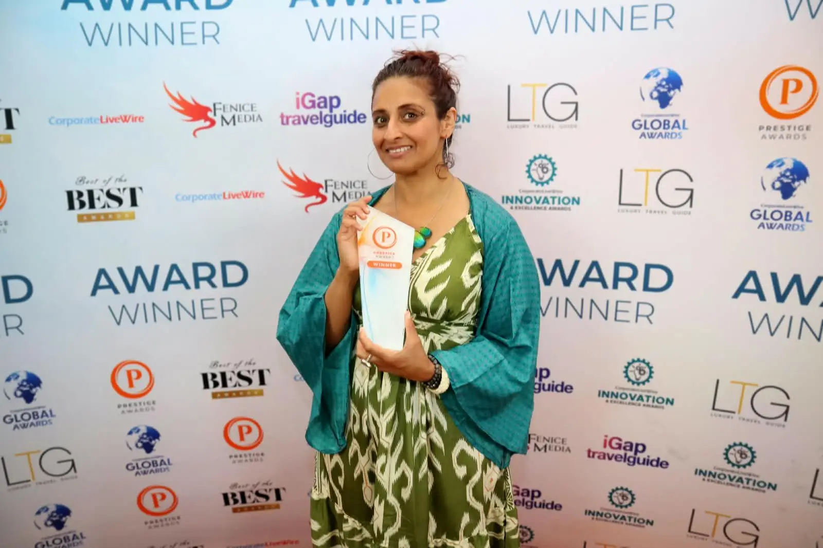 Salonee Batavia of Spacious Wings Therapies holding her Prestige Awards winner trophy
